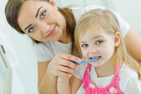 Mom and Daughter brushing their teeth - Pediatric Dentist in Jackson, New Jersey